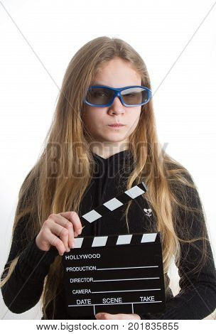 Teenage girl in black clothes blonde with long hair is holding clapperboard on white background