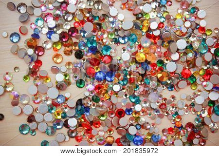 Rhinestone background. Mix of Shiny rhinestones crystals texture as backdrop isolated white studio photo.