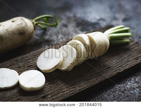 Closeup of cut daikon radish on wooden cutboard