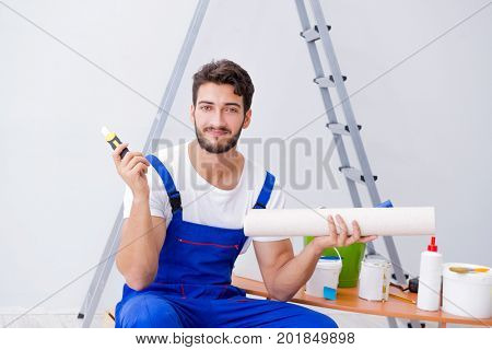 Repairman doing renovation repair in the house with paper wallpa