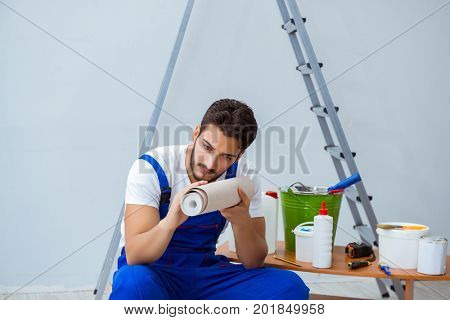 Repairman doing renovation repair in the house with paper wallpa
