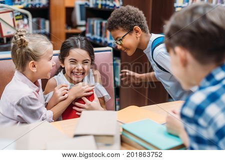 laughing kids having fun in school library