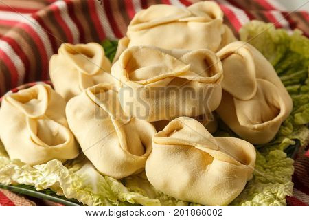Frozen Dumplings On The White Plate With Green