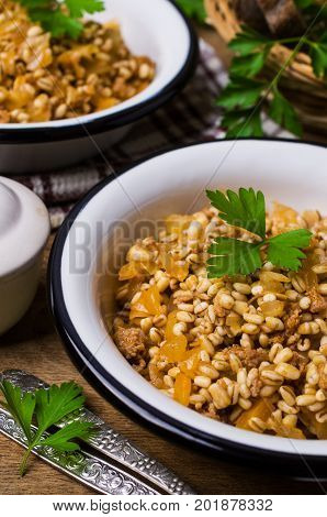 Pearl barley with vegetables and minced meat. Selective focus.