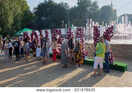 Donetsk Ukraine - August 27 2017: Citizens at the installation with the name of the city in the park named after Shcherbakov during the celebration of the city day