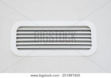 New white air conditioning vent on wall closeup