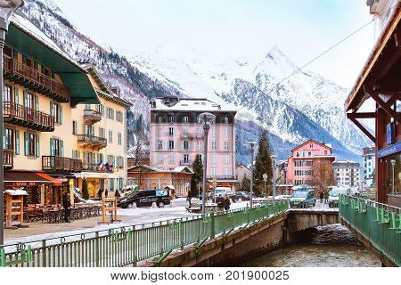 Chamonix, France - January 21, 2015: Street view, river, houses, people walking in the center of Chamonix
