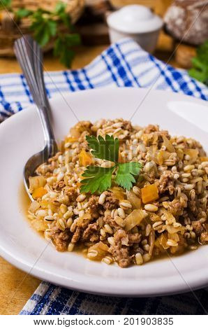 Pearl barley with vegetables and minced meat. Selective focus.