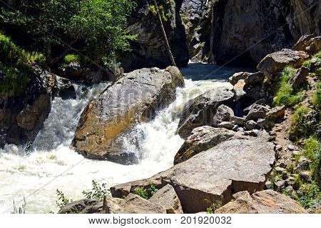 River and waterfall in forest, mountains of Caucasus, Russia.