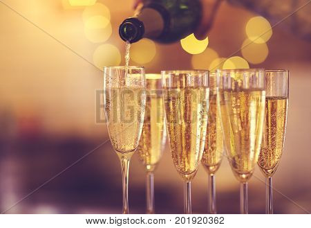 Champagne glasses on gold background. Party and holiday celebration concept