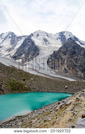 lake and waterfall in forest, mountains of Caucasus, Russia.