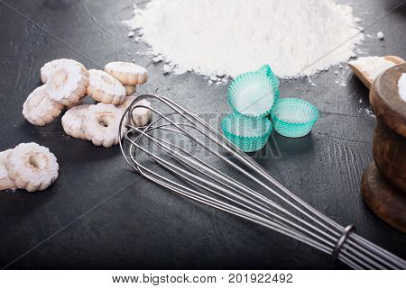Blender whip and canestrelli Italian shortbread cookies on black table