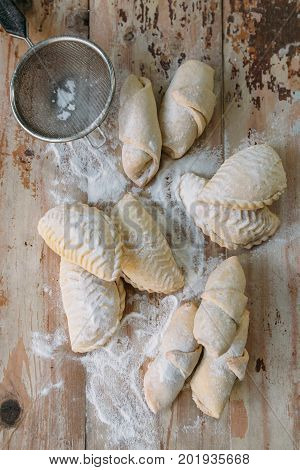 Roll cookies with nuts on a wooden table. Georgian dessert. Croissants, pastry rolls