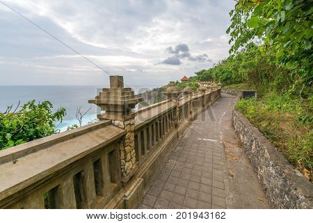 Landscape in Uluwatu Temple Bali Indonesia.
Landscape of high cliff with sunset sky at Uluwatu Temple Bali Indonesia.