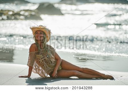 young woman relaxing on the beach in summer day