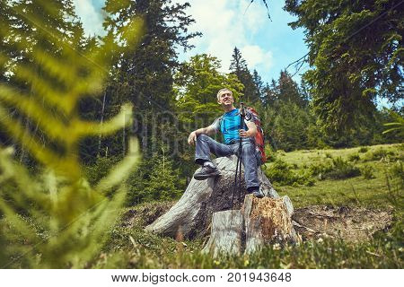 Hiking in the mountains with a backpack in the summer.