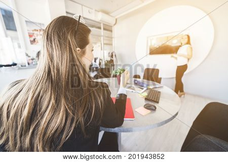 Business meeting. Businesswoman pointing to presenting worker with question. Woman question