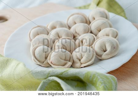 Frozen Dumplings On The White Plate With Green