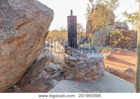 HOADA NAMIBIA - JUNE 27 2017: A wood-fired donkey provides hot water for the showers in the back at the Hoada Rest Camp in the Kunene Region of Namibia