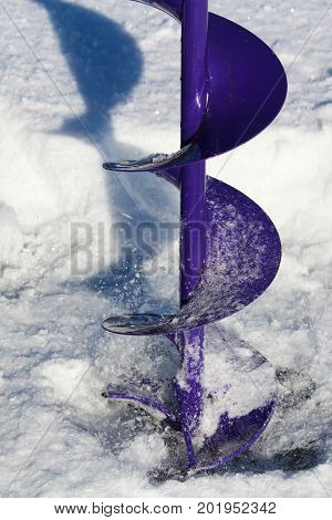 Close-up of Drilling an Ice Fishing Hole.
