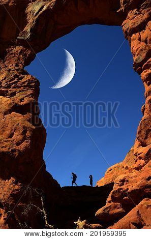Silhouette of hiker in arch canyon rock formations