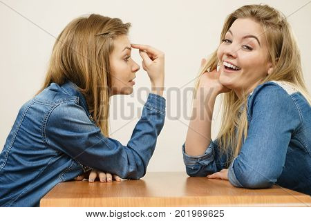 Woman Mocking Her Confident Friend