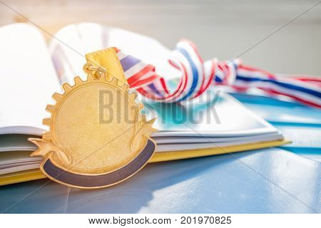 Golden medals on book graduate education in university Competitions and Education study concepts. Success in study famous institution Concept of winner abroad international.