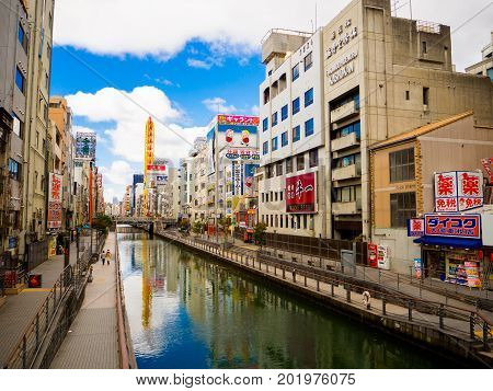 OSAKA, JAPAN - JULY 18, 2017: Unidentified people walking around of Dotonbori district surrounding of sign advertisements at Numba area, in a cloudy day in Osaka City, Japan.