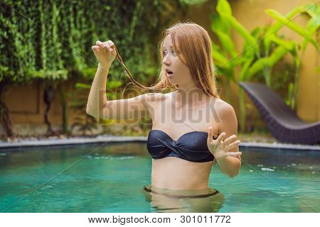 Frustrated Young Woman Having A Bad Hair In The Pool. Due To The Fact That Chemicals In The Pool