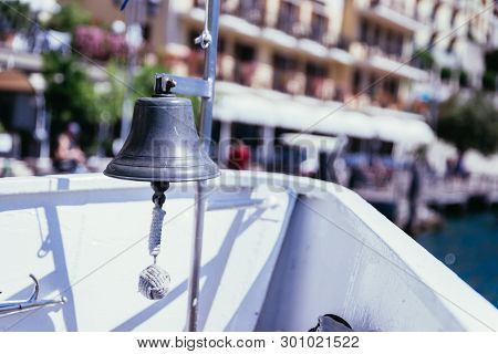 Boat Tour: Boat Bow With Boat Bell, View Over Azure Blue Water, Mountain Range And Little Village. L