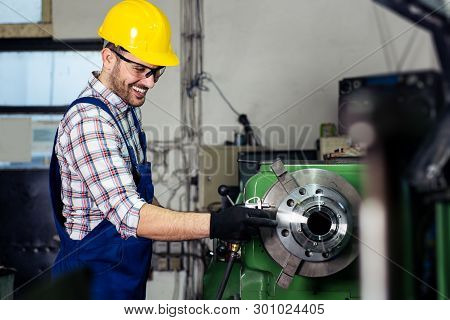 Turner Worker Is Working On A Lathe Machine In A Factory.