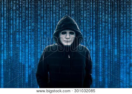 Hooded computer hacker with white mask 