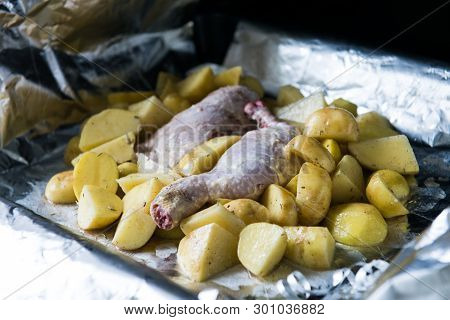 Raw Chicken Leg With Potatoes Ready To Be Cooked. Raw Chicken With Raw Potatoes In The Form For Baki