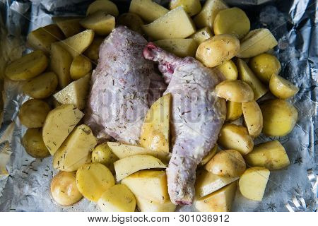 Raw Chicken Leg With Potatoes Ready To Be Cooked. Raw Chicken With Raw Potatoes In The Form For Baki