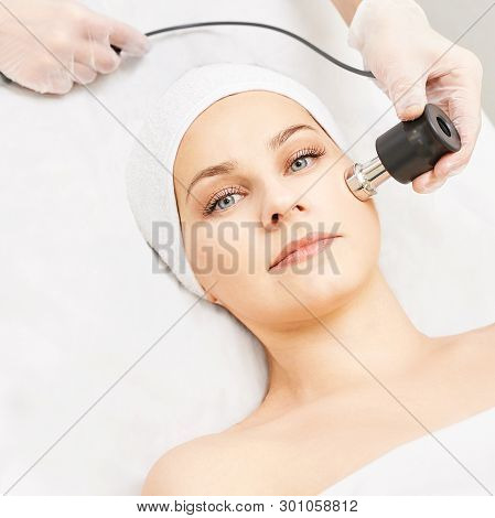 Electroporation Woman Face Treatment. Facial Rejuvenation Therapy. Cosmetology Skin Spa Equipment. R