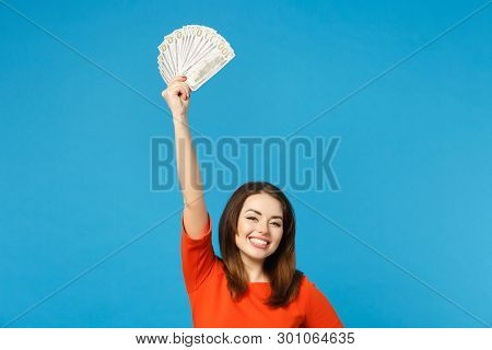 Beautiful Brunette Young Woman Wearing Red Orange Dress Holding Fan Of Cash Money In Dollar Banknote