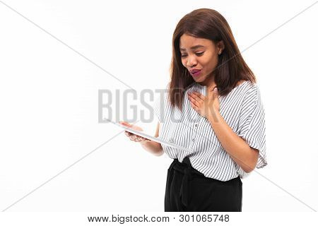 Portrait Of African Young Girl Possing With Grey Tablet In Hands On Background