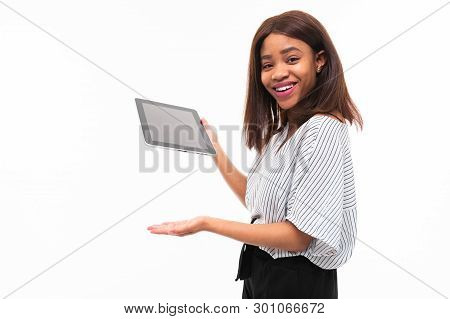 Portrait Of African Young Girl Possing With Grey Tablet In Hands On Background