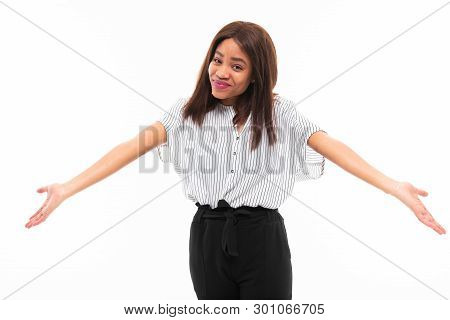 Portrait Of African Young Girl Possing And Gesticulates Hands On Background