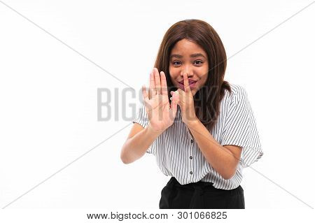 Portrait Of African Young Girl Possing And Gesticulates Hands On Background
