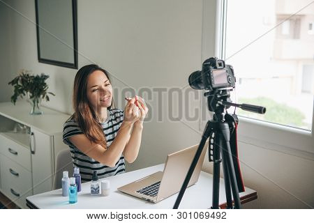 Girl Videoblogger Or Beauty Blogger Records Video For Subscribers. She Shows Lipstick And Tells How 