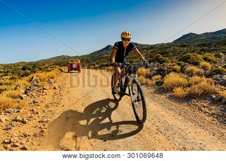 Cycling woman on electric bikes. Cycling MTB enduro trail track. Outdoor sport activity.