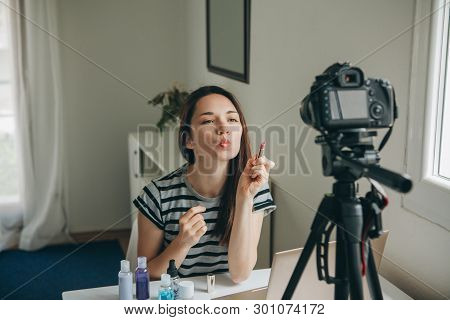 Girl Videoblogger Or Beauty Blogger Records Video For Subscribers. She Shows Lipstick And Tells How 