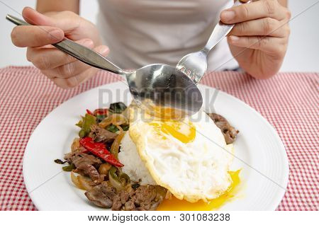 Fried rice with basil leaves and red cloth on the table.Ngredients of Basil Fried Chicken and fried 