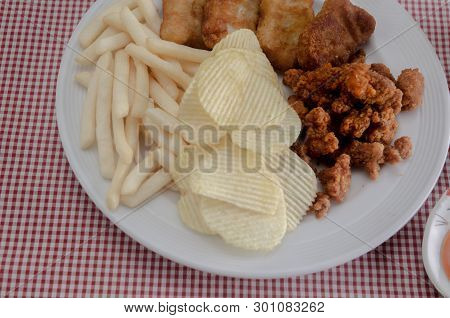 Fried rice with basil leaves and red cloth on the table.Ngredients of Basil Fried Chicken and fried 
