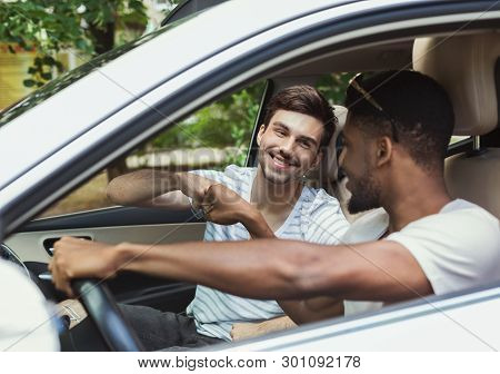 Happy Millennials Friends Traveling By Car, Making Fist Bump