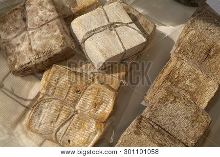 Forms With Freshly Made Cheese On Wooden Table