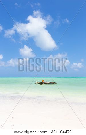 Fishing Boat On Picture Perfect White Sandy Beach With Turquoise Blue Sea, Paje, Zanzibar, Tanzania.