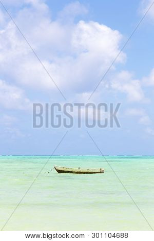 Fishing Boat On Picture Perfect White Sandy Beach With Turquoise Blue Sea, Paje, Zanzibar, Tanzania.