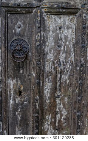 Ancient Wooden Door. Door Has Lovely Black Metal Patterned Clasp And Studded Pattern.  Shows Great T